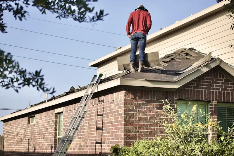 Professional roofer working on a residential roof in Neenah